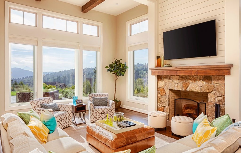 Modern living room with windows displaying a scenic view